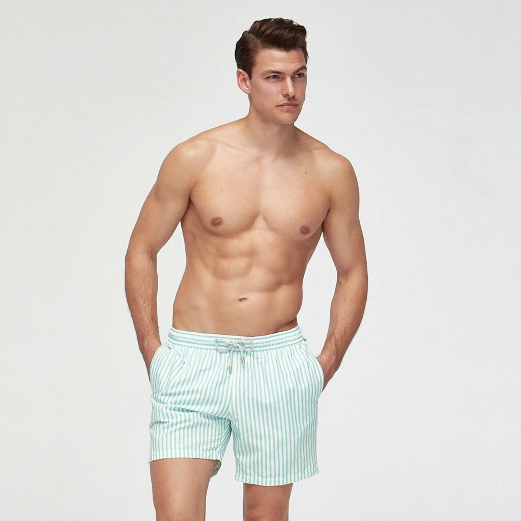 muscular guy in striped swimming shorts